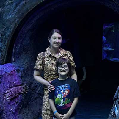 Corinne and her son at an aquarium